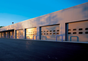 Long row of commercial garage doors in a warehouse.